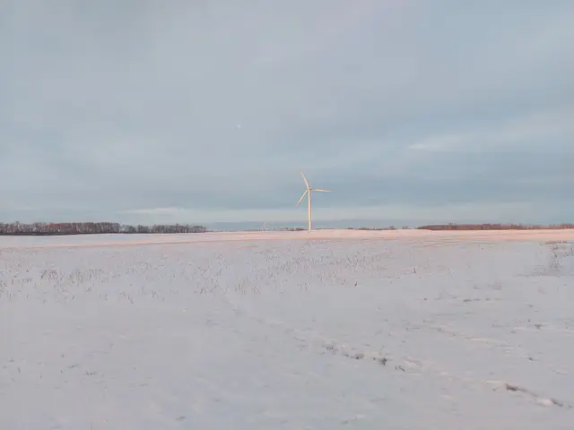 Wind turbine over snowy field, Red Lily Wind Farm